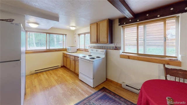 kitchen featuring light wood-type flooring, a baseboard heating unit, and white appliances