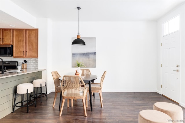 dining area featuring dark wood-type flooring