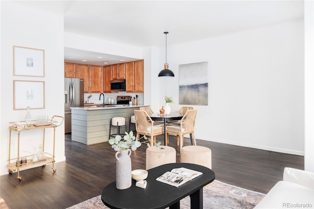 living room with sink and dark hardwood / wood-style floors