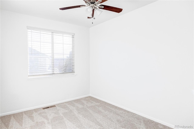 carpeted empty room featuring ceiling fan