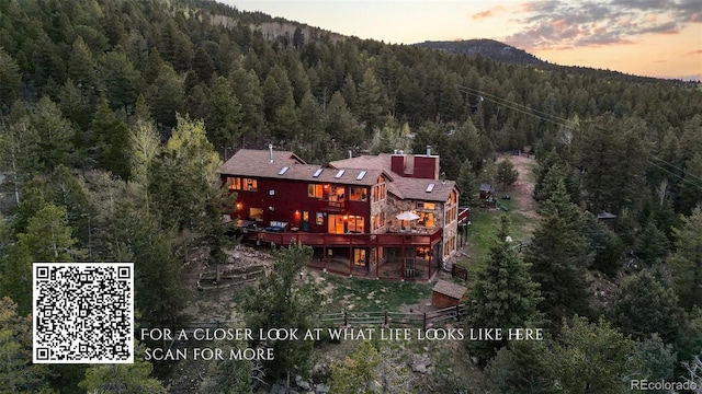 30717 Conifer Mountain Dr, Conifer, CO 80433 - aerial view of property and surrounding area with a heavily wooded area and mountains