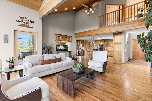 30717 Conifer Mountain Dr, Conifer, CO 80433 - living room featuring high vaulted ceiling, a ceiling fan, light wood-style floors, a wood ceiling with exposed beams, and a baseboard heating unit