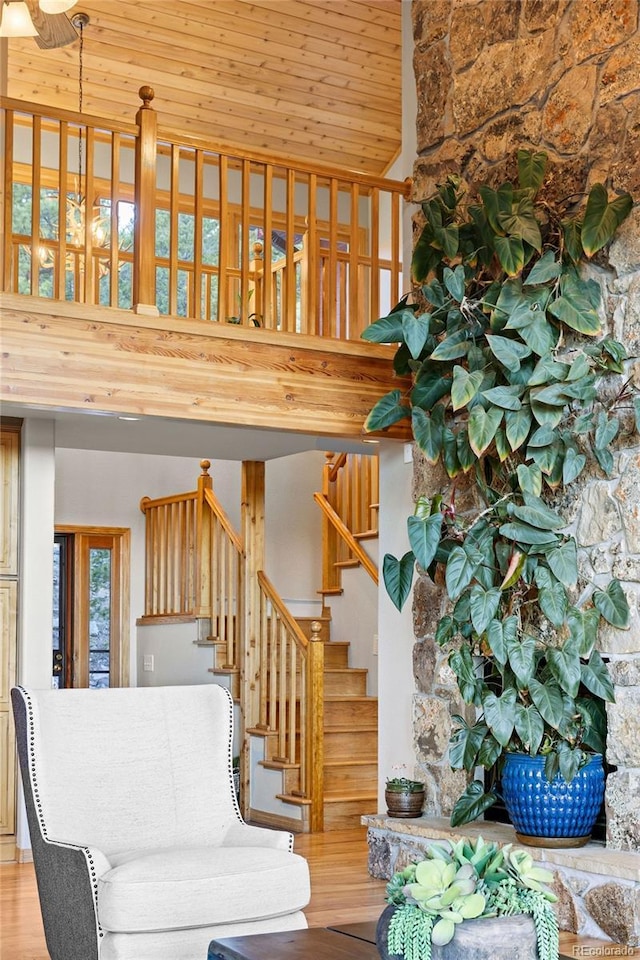 30717 Conifer Mountain Dr, Conifer, CO 80433 - stairway featuring wooden ceiling, wood finished floors, and a high ceiling