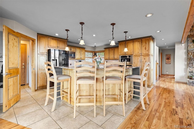 30717 Conifer Mountain Dr, Conifer, CO 80433 - kitchen with stainless steel appliances, recessed lighting, pendant lighting, a breakfast bar, and a large island