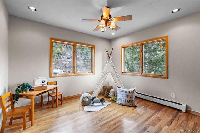30717 Conifer Mountain Dr, Conifer, CO 80433 - rec room featuring baseboard heating, ceiling fan, wood finished floors, and recessed lighting
