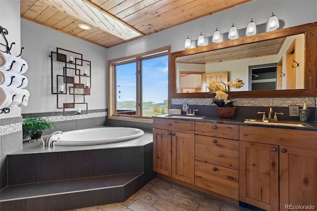 30717 Conifer Mountain Dr, Conifer, CO 80433 - full bath featuring decorative backsplash, double vanity, a garden tub, and wooden ceiling