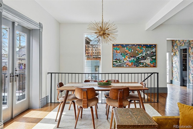 dining area featuring a chandelier, wood finished floors, and beamed ceiling