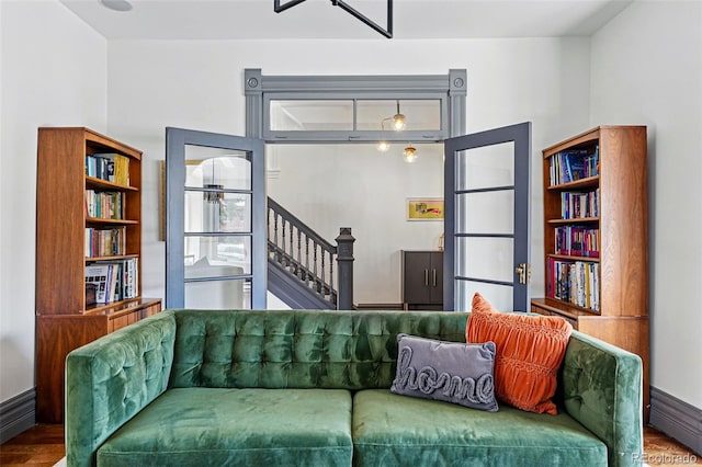 living area with wood finished floors and stairs