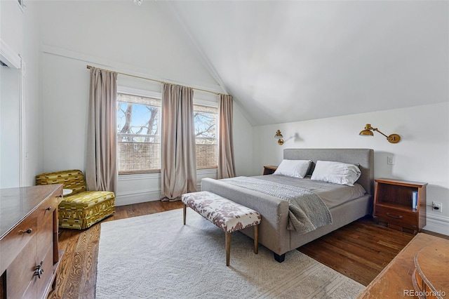 bedroom featuring wood finished floors, lofted ceiling, and baseboards
