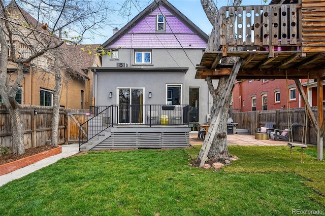 back of property featuring stucco siding, a patio, and a deck