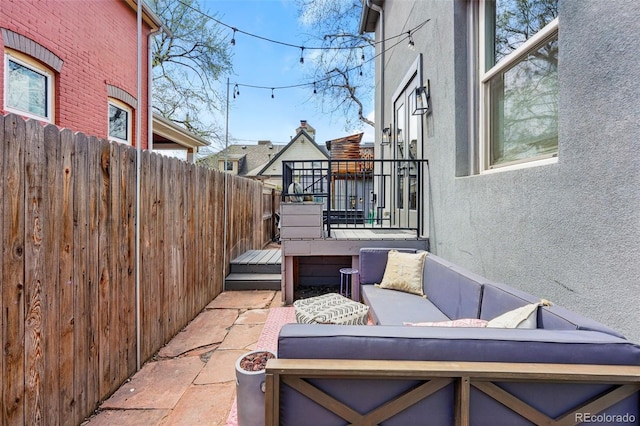 view of patio with an outdoor living space and fence