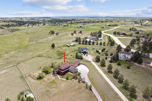 aerial view of property and surrounding area featuring rural landscape