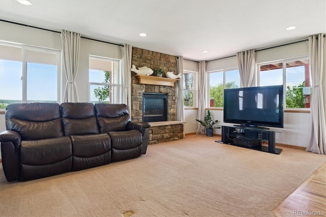 living room with plenty of natural light, baseboards, recessed lighting, wood finished floors, and a fireplace