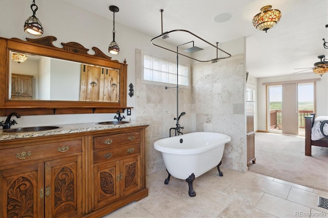 full bathroom featuring a freestanding tub, tile walls, double vanity, a shower, and tile patterned flooring
