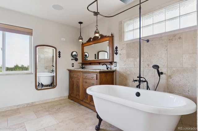 bathroom with a freestanding tub and double vanity