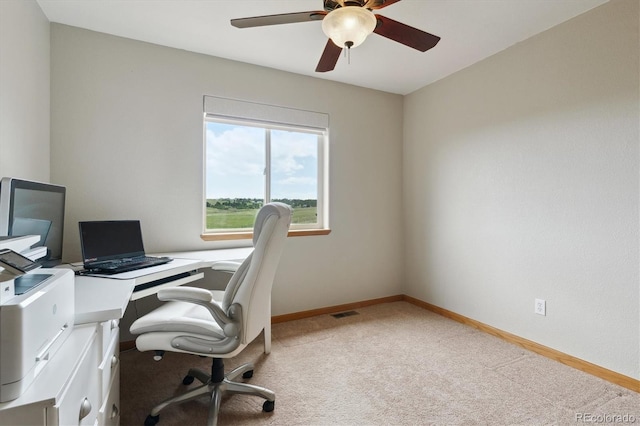 office space with carpet flooring, a ceiling fan, and baseboards