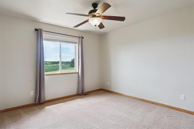 unfurnished room with light carpet, ceiling fan, and baseboards