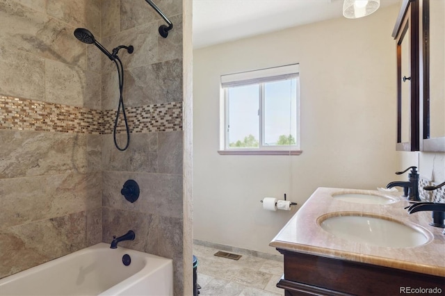 full bath with shower / tub combination, baseboards, and double vanity