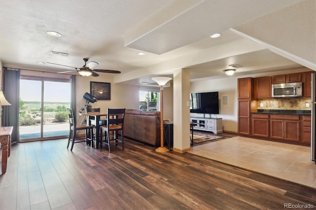 dining room featuring wood finished floors, ceiling fan, recessed lighting, a textured ceiling, and baseboards