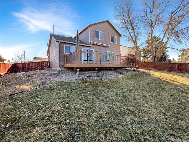 back of house featuring a wooden deck and a lawn