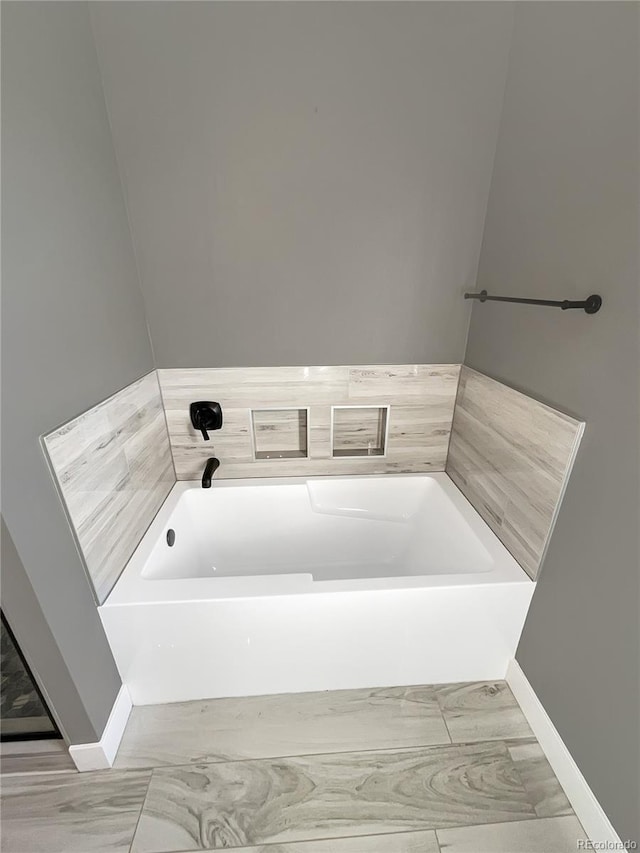 bathroom with a tub to relax in