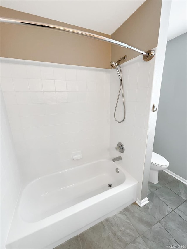 bathroom featuring washtub / shower combination and toilet