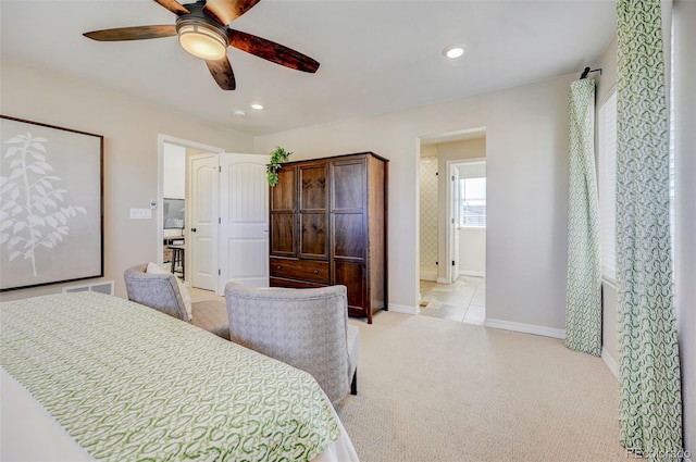 bedroom featuring light colored carpet and ceiling fan