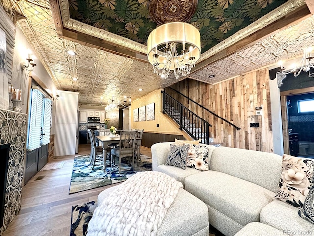 10704 Engelmann Ave, Salida, CO 81201 - living room with a chandelier, stairway, wood-type flooring, an ornate ceiling, and wooden walls