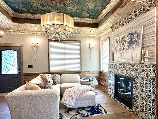10704 Engelmann Ave, Salida, CO 81201 - living room featuring a wainscoted wall, a chandelier, wood finished floors, a high end fireplace, and wooden walls