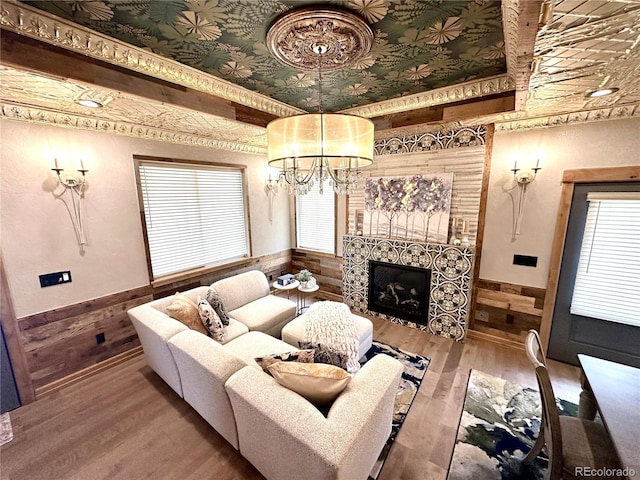 10704 Engelmann Ave, Salida, CO 81201 - living area with wainscoting, a chandelier, wood walls, wood finished floors, and plenty of natural light