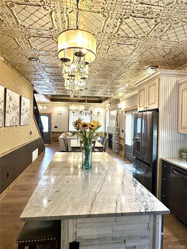 10704 Engelmann Ave, Salida, CO 81201 - dining space featuring an ornate ceiling, a chandelier, ornamental molding, wood finished floors, and wainscoting