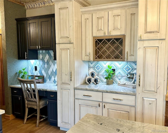 10704 Engelmann Ave, Salida, CO 81201 - kitchen featuring wood finished floors, tasteful backsplash, and light stone countertops