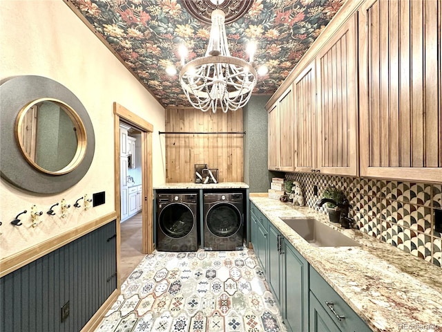 10704 Engelmann Ave, Salida, CO 81201 - laundry room with washer and clothes dryer, cabinet space, and a chandelier