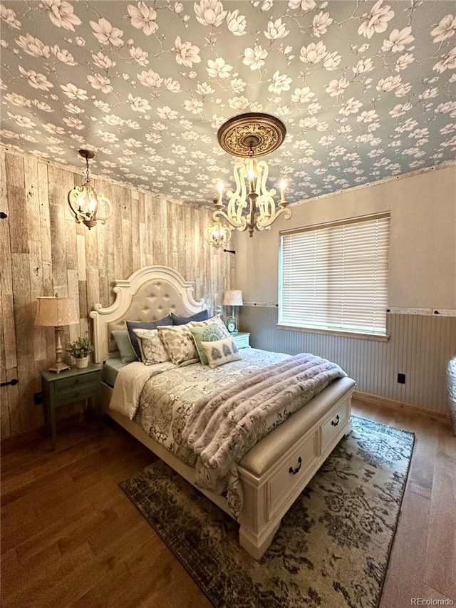 10704 Engelmann Ave, Salida, CO 81201 - bedroom with a chandelier, dark wood-style floors, wood walls, and a wainscoted wall