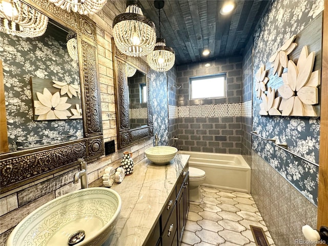 10704 Engelmann Ave, Salida, CO 81201 - full bathroom with a chandelier, wallpapered walls, toilet, double vanity, and bathing tub / shower combination