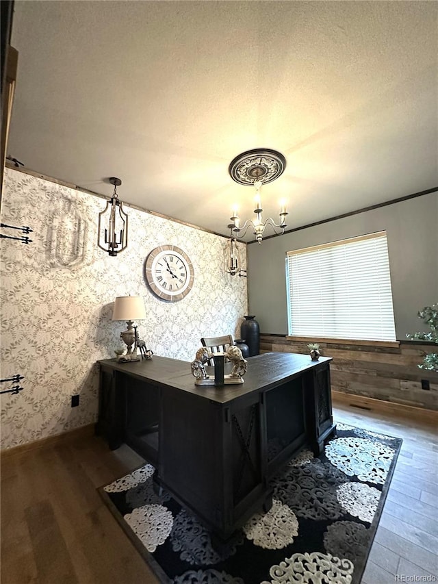 10704 Engelmann Ave, Salida, CO 81201 - office space with wallpapered walls, dark wood-style floors, a chandelier, and a textured ceiling