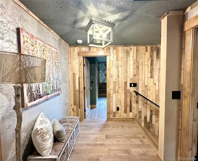 10704 Engelmann Ave, Salida, CO 81201 - corridor with wood finished floors, a textured ceiling, and wood walls