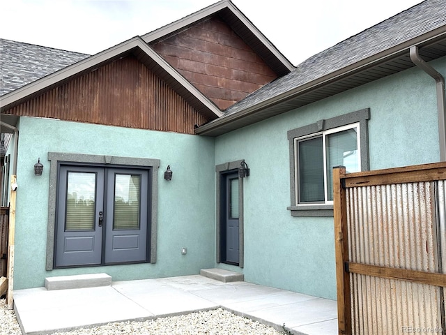 10704 Engelmann Ave, Salida, CO 81201 - entrance to property featuring french doors, a shingled roof, and stucco siding