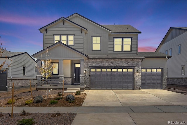 24563 E 34th Ave, Aurora, CO 80019 - view of front of property with a porch, stone siding, concrete driveway, and a garage
