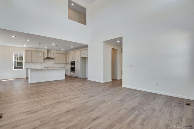 24563 E 34th Ave, Aurora, CO 80019 - unfurnished living room with recessed lighting, light wood-style flooring, and baseboards