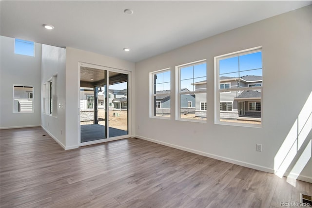 24563 E 34th Ave, Aurora, CO 80019 - empty room with wood finished floors, baseboards, and recessed lighting