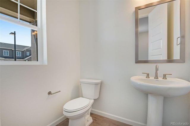 24563 E 34th Ave, Aurora, CO 80019 - bathroom with baseboards, wood finished floors, and toilet