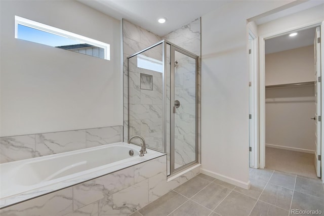 24563 E 34th Ave, Aurora, CO 80019 - full bath with a shower stall, a walk in closet, a garden tub, baseboards, and recessed lighting