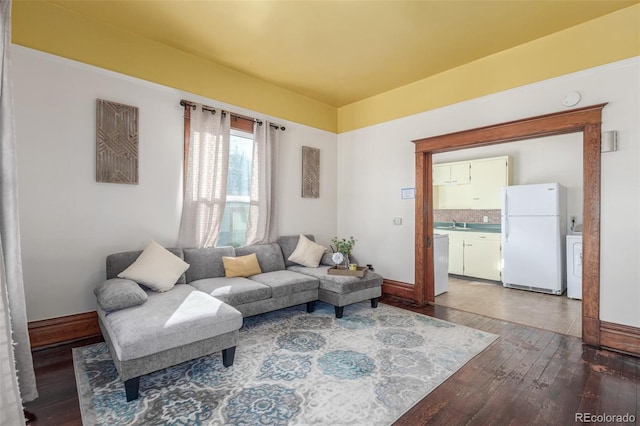 living room with washer / clothes dryer and hardwood / wood-style floors