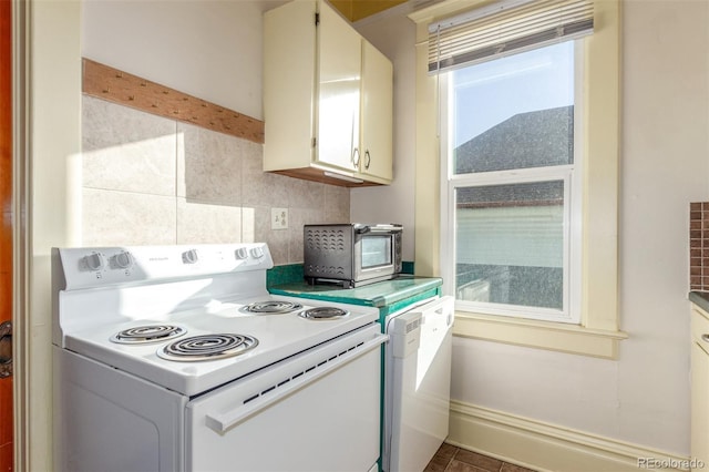 kitchen with white cabinetry, backsplash, and white appliances