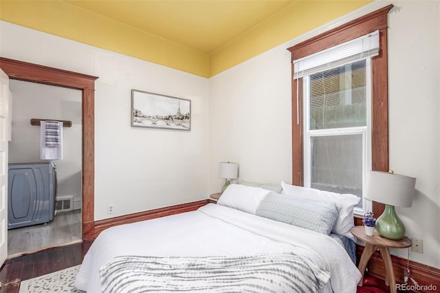 bedroom with dark hardwood / wood-style flooring