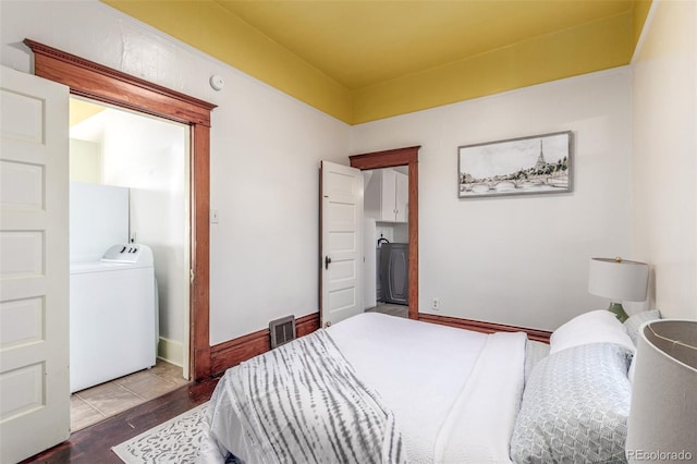 bedroom featuring wood-type flooring and washer / dryer