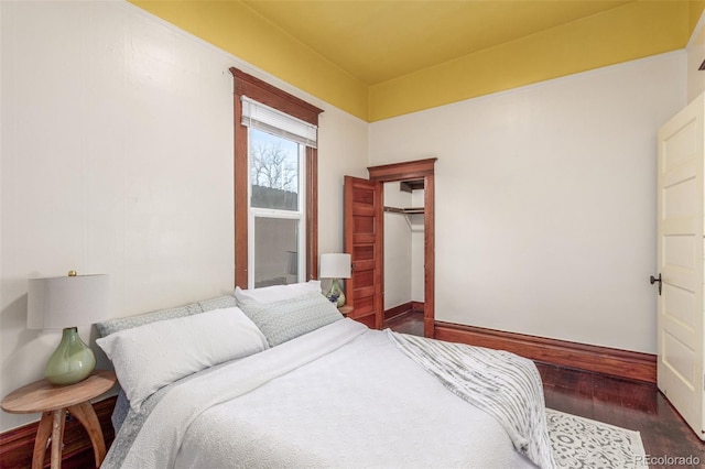 bedroom featuring dark hardwood / wood-style flooring and a closet