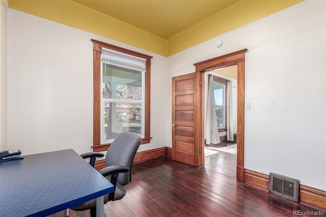 office space with dark wood-type flooring and a healthy amount of sunlight