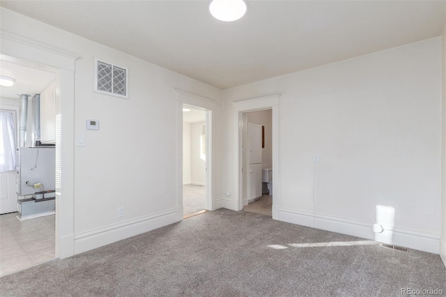 unfurnished room with light carpet